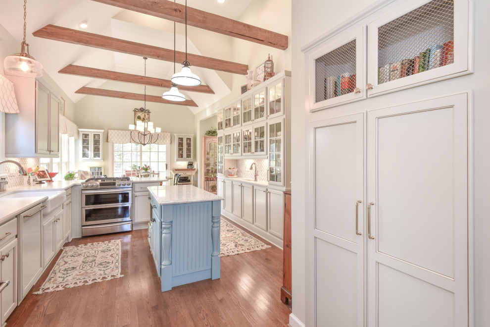 Kitchen - large transitional u-shaped kitchen idea in DC Metro with a farmhouse sink, recessed-panel cabinets, quartz countertops, stainless steel appliances and an island