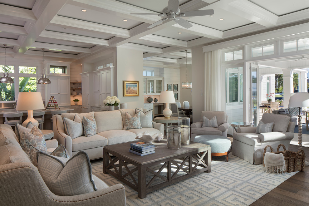 Beach style living room in Miami with beige walls and dark hardwood floors.
