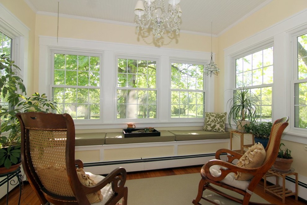 This is an example of a mid-sized traditional sunroom in Milwaukee with medium hardwood floors, no fireplace and a standard ceiling.