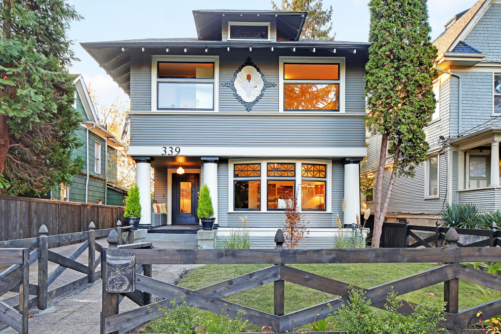 Large arts and crafts two-storey blue house exterior in Seattle.