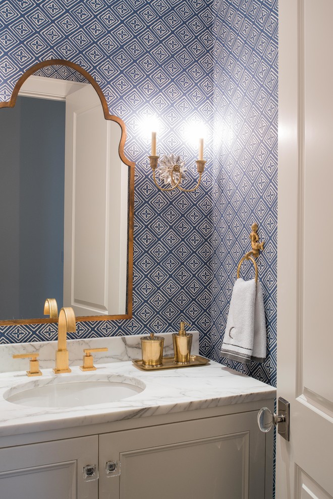 This is an example of a mid-sized transitional bathroom in Dallas with an undermount sink, white cabinets, marble benchtops, blue walls and recessed-panel cabinets.