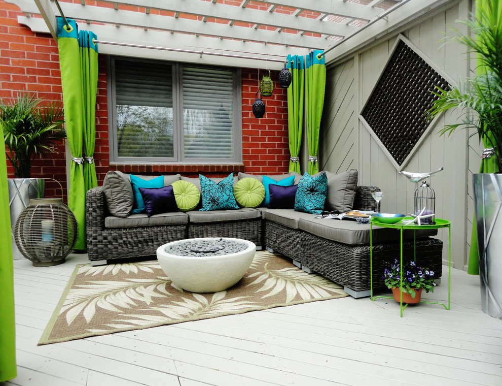 This is an example of a contemporary backyard patio in Toronto with a pergola and decking.