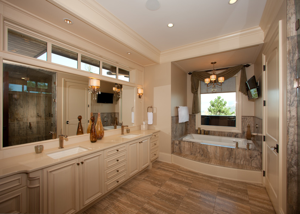Inspiration for a mid-sized master beige tile and porcelain tile porcelain tile and beige floor alcove shower remodel with raised-panel cabinets, beige cabinets, beige walls, an undermount sink, quartz countertops and a hinged shower door