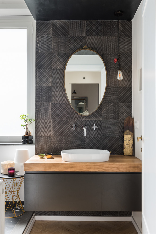 Contemporary master bathroom in Rome with flat-panel cabinets, black cabinets, porcelain tile, white walls, light hardwood floors, a vessel sink, wood benchtops, brown benchtops, black tile and brown floor.
