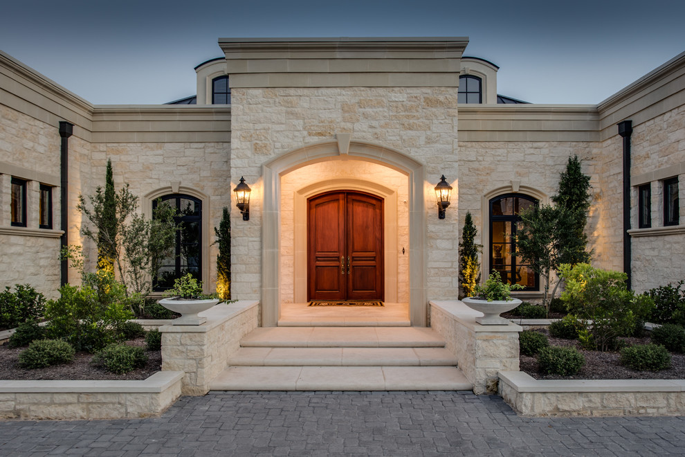 Design ideas for a large mediterranean front door in Austin with white walls, concrete floors, a double front door, a dark wood front door and white floor.