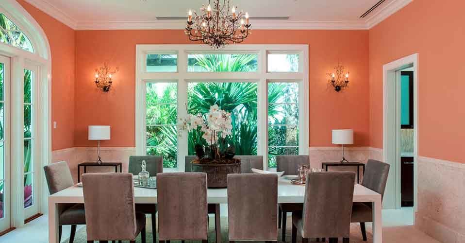 Design ideas for a large transitional separate dining room in Miami with orange walls, porcelain floors and no fireplace.