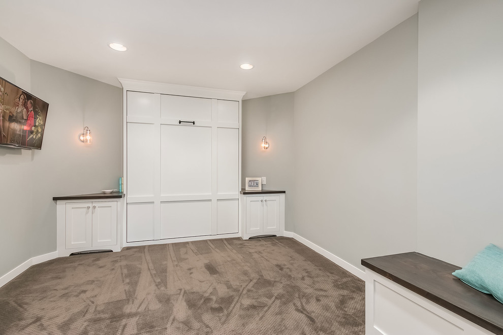 Photo of a large transitional look-out basement in Minneapolis with grey walls, carpet, a two-sided fireplace, a stone fireplace surround and grey floor.