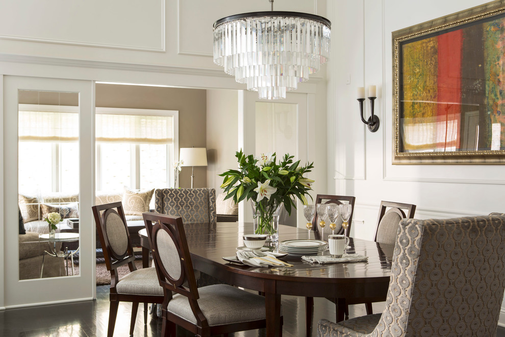 This is an example of a transitional separate dining room in Minneapolis with white walls.
