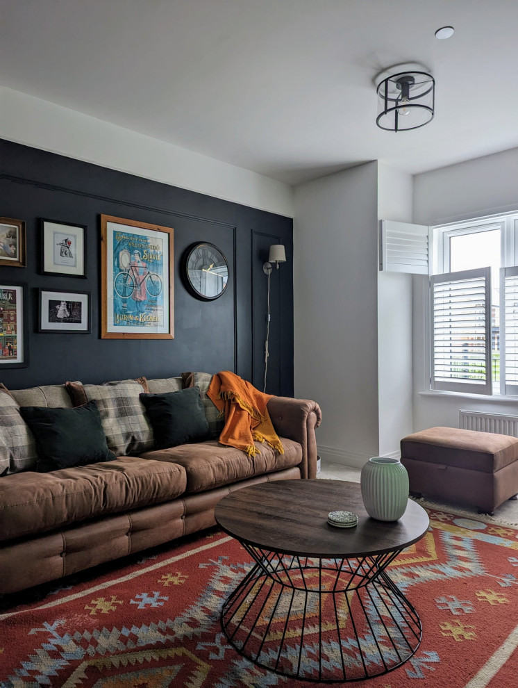 Design ideas for a medium sized eclectic formal and grey and brown enclosed living room feature wall in Cambridgeshire with black walls, a wall mounted tv, carpet, beige floors and wainscoting.