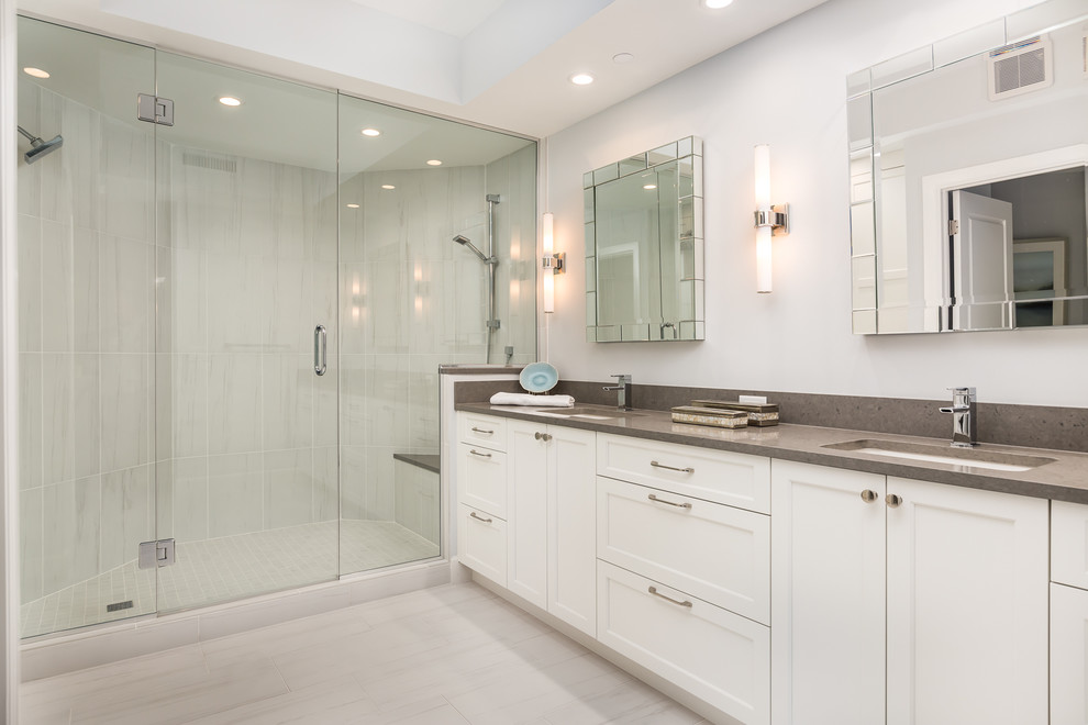 Design ideas for a large transitional master bathroom in Miami with recessed-panel cabinets, white cabinets, a double shower, white walls, an undermount sink, granite benchtops, porcelain floors, beige floor and a hinged shower door.
