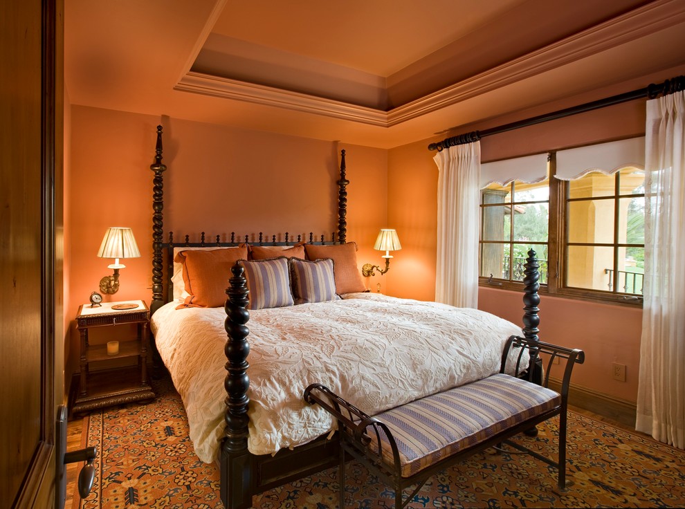 This is an example of a mediterranean bedroom in Santa Barbara with orange walls.