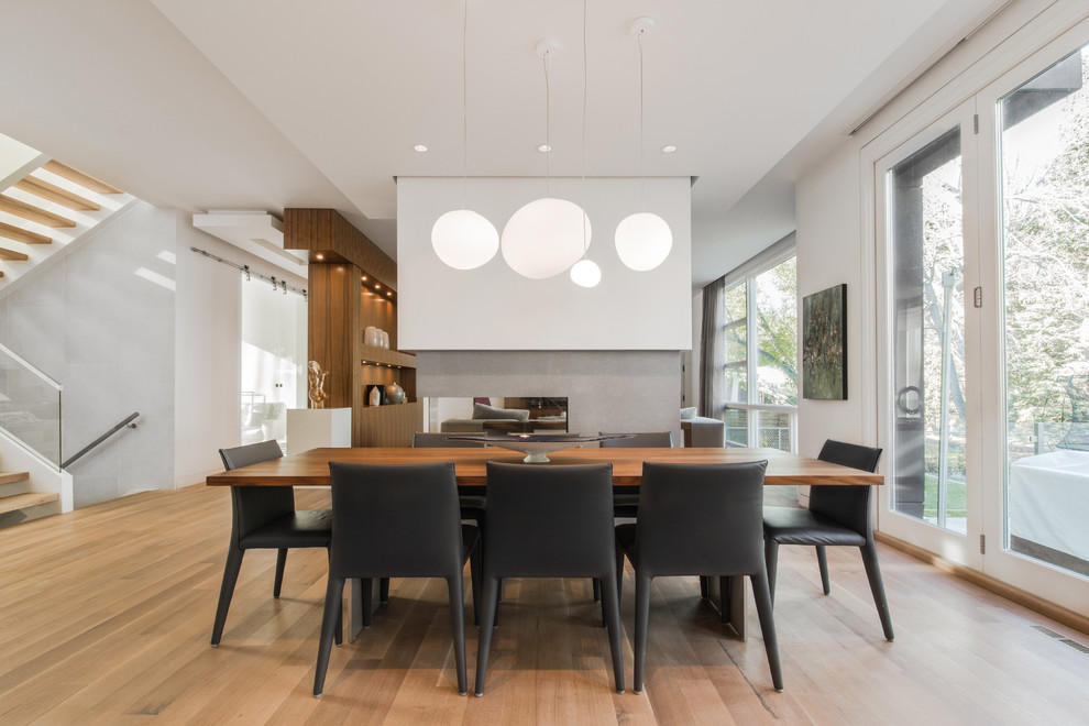 Photo of an expansive modern kitchen/dining combo in Calgary with light hardwood floors.