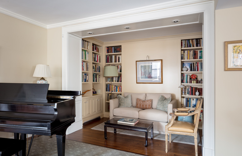 Large traditional open concept living room in New York with a library, beige walls, medium hardwood floors, no fireplace, no tv and brown floor.