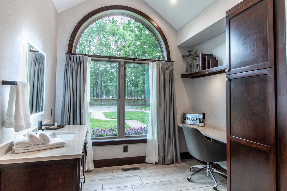 Mid-sized transitional bathroom in Other with shaker cabinets, dark wood cabinets, ceramic floors, an undermount sink, engineered quartz benchtops, grey floor, white benchtops and grey walls.