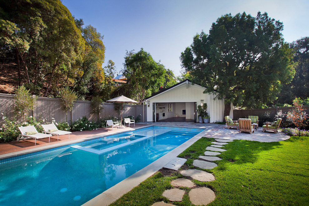 Inspiration for a traditional pool in Los Angeles with decking and a pool house.