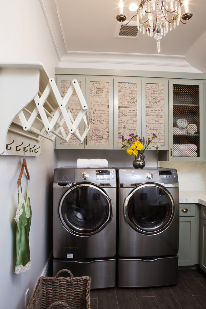 Dedicated laundry room - traditional black floor dedicated laundry room idea in San Francisco with recessed-panel cabinets and a side-by-side washer/dryer