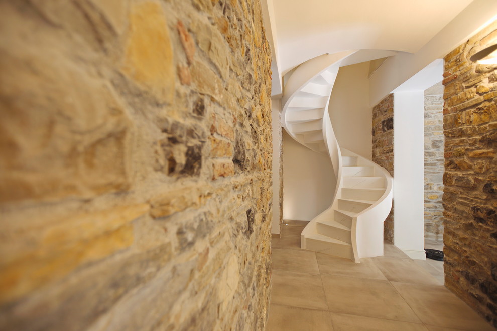 This is an example of a small modern marble spiral staircase in Other with marble risers.