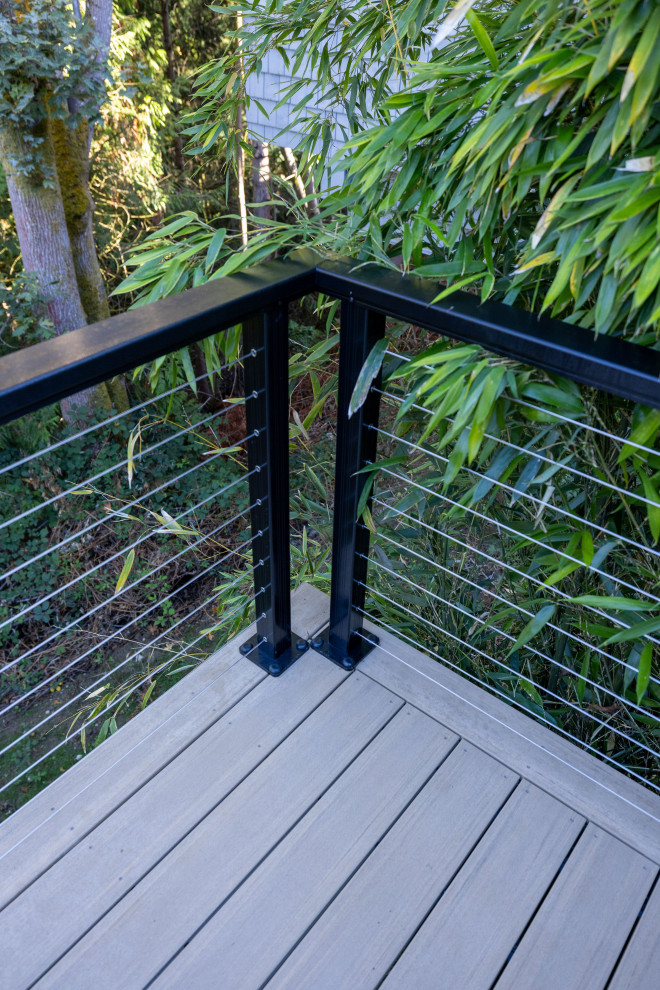 Inspiration for a mid-sized backyard second story cable railing deck remodel in Seattle