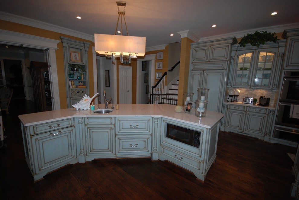 Inspiration for a large transitional kitchen remodel with raised-panel cabinets, marble countertops, multicolored backsplash and ceramic backsplash