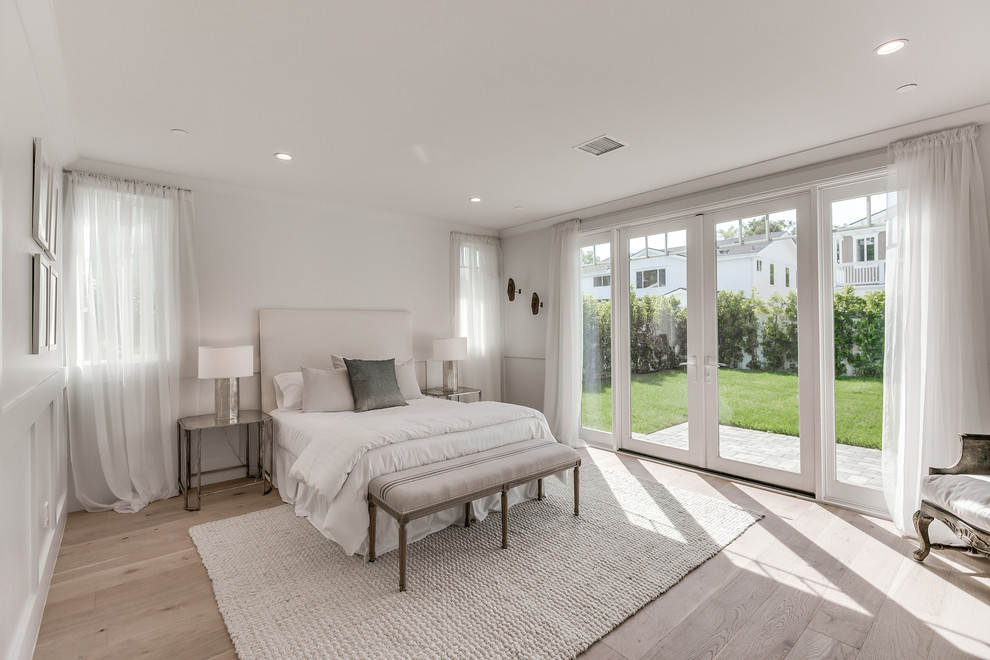 Inspiration for a mid-sized contemporary master bedroom in Los Angeles with white walls, light hardwood floors, no fireplace and brown floor.