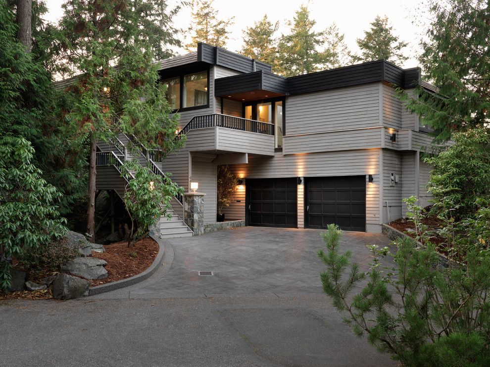 This is an example of a contemporary two-storey beige exterior in Vancouver.