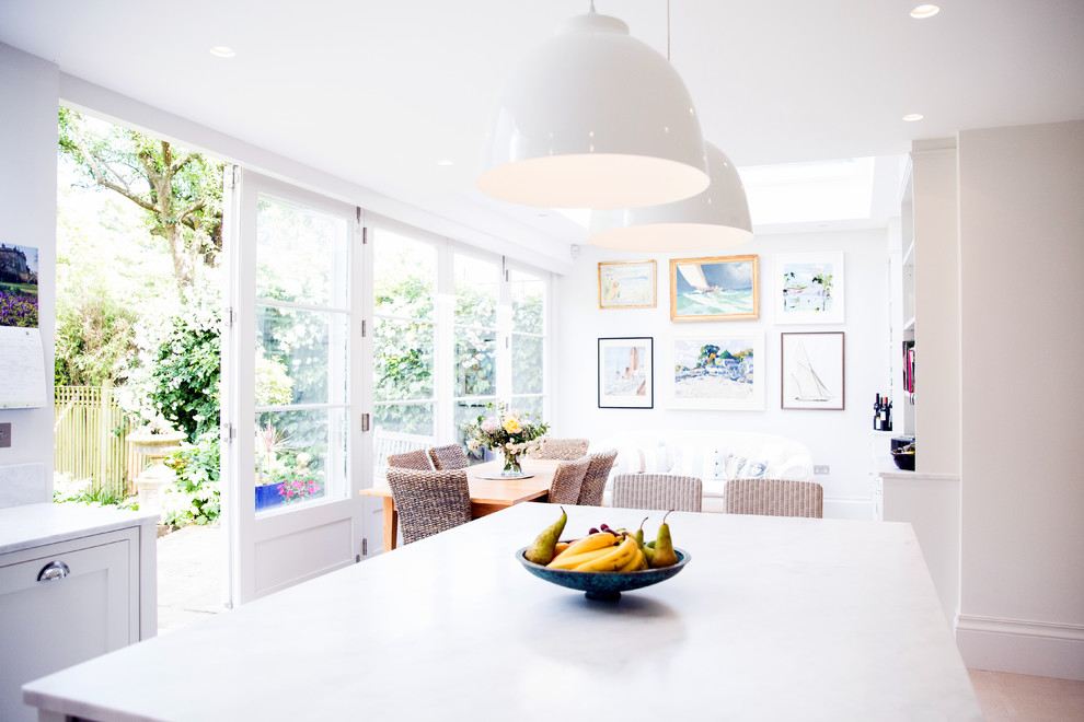 Inspiration for a mid-sized traditional kitchen/dining combo in London with white walls.