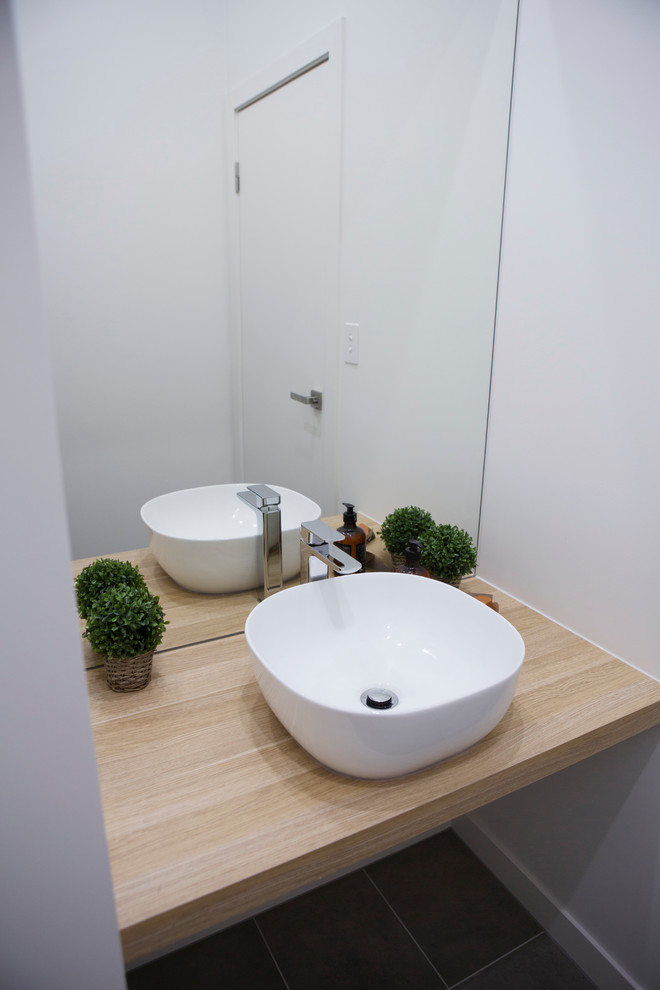 Inspiration for a small contemporary powder room in Melbourne with white walls, ceramic floors, a vessel sink, wood benchtops and brown benchtops.