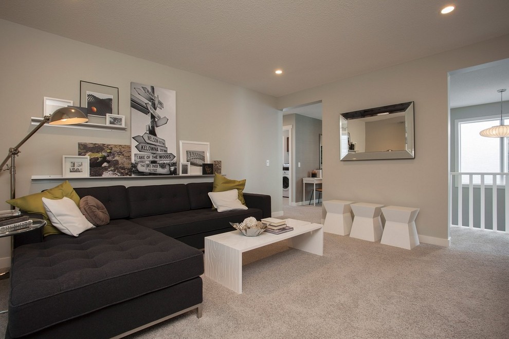 This is an example of a contemporary family room in Edmonton with beige walls and carpet.