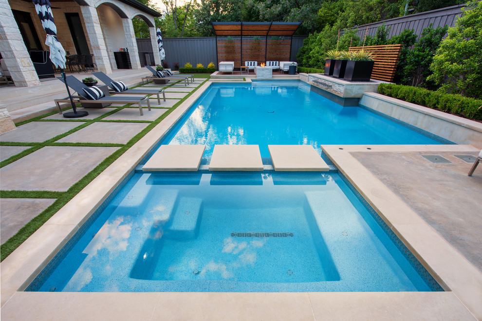 Photo of a mid-sized modern backyard rectangular pool in Dallas with a hot tub and concrete slab.