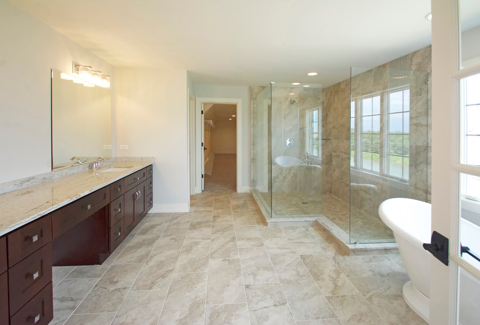 Inspiration for a large transitional master bathroom in Chicago with shaker cabinets, dark wood cabinets, a freestanding tub, a corner shower, beige tile, travertine, white walls, travertine floors, an undermount sink, beige floor and an open shower.