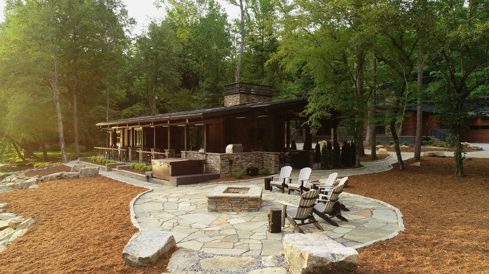Mid-sized contemporary backyard patio in Raleigh with a fire feature, natural stone pavers and no cover.