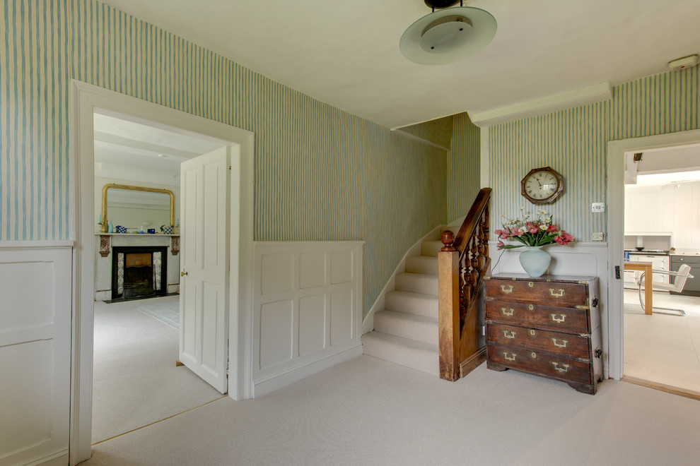 This is an example of a country foyer in Other with green walls and carpet.