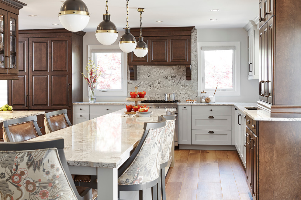 Eat-in kitchen - large transitional l-shaped ceramic tile eat-in kitchen idea in Toronto with an undermount sink, raised-panel cabinets, dark wood cabinets, quartz countertops, gray backsplash, stone slab backsplash, paneled appliances and an island