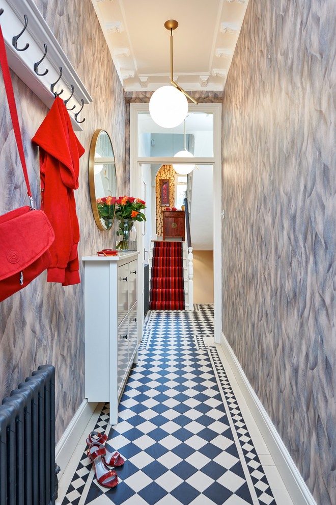 Eclectic hallway in London with grey walls.