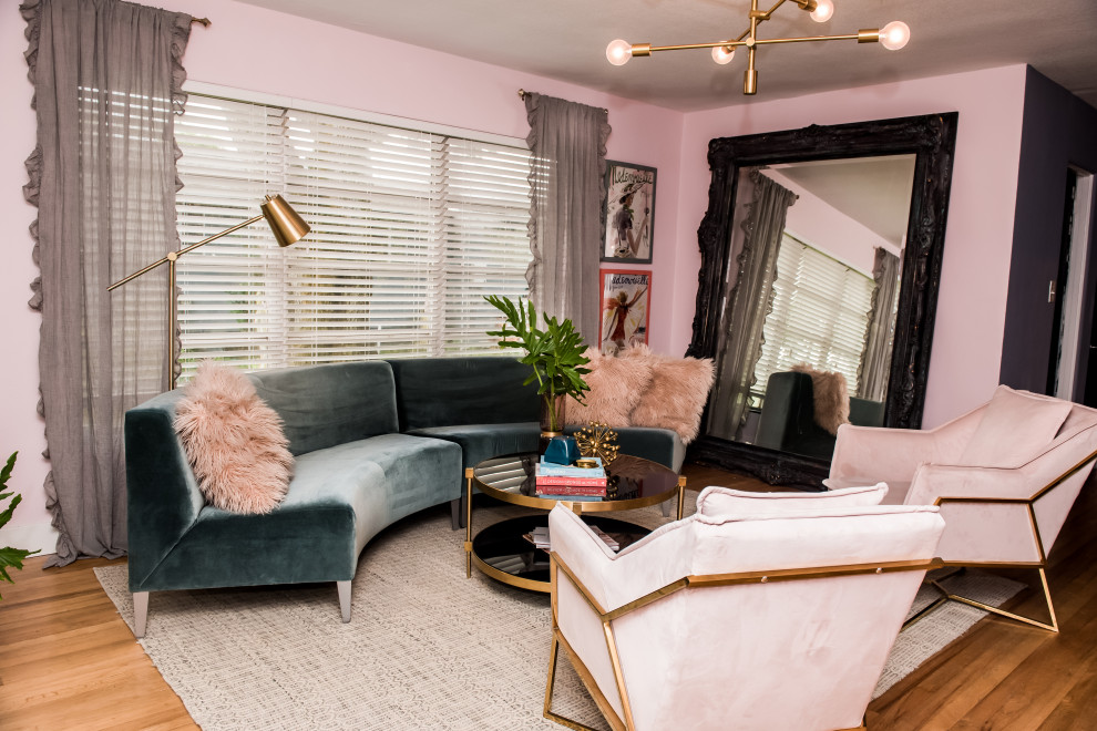 Photo of a mid-sized midcentury open concept living room in Tampa with pink walls, light hardwood floors and a freestanding tv.