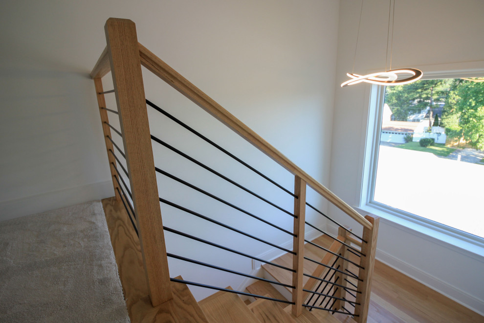 Design ideas for a medium sized contemporary wood floating mixed railing staircase in DC Metro with painted wood risers and tongue and groove walls.
