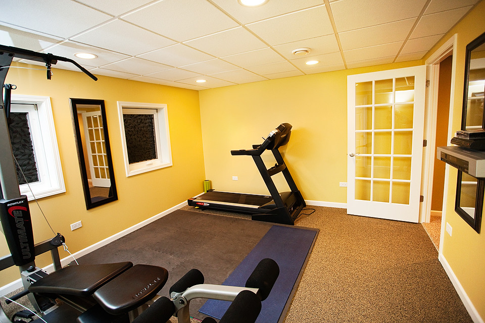 This is an example of a mid-sized modern multipurpose gym in Chicago with yellow walls and carpet.