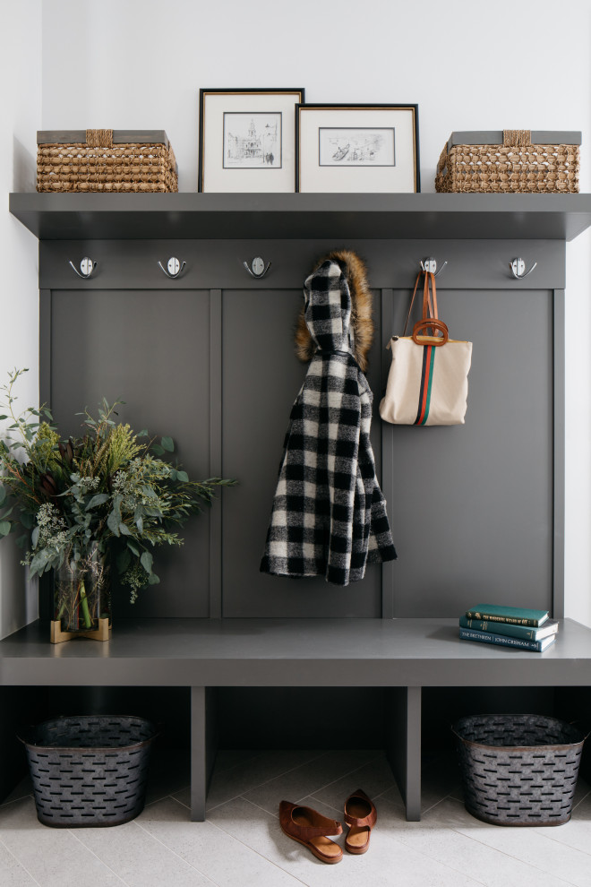 This is an example of a transitional mudroom in Chicago with white walls and grey floor.