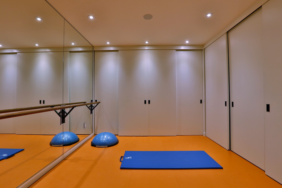This is an example of a small modern home yoga studio in Other with white walls.