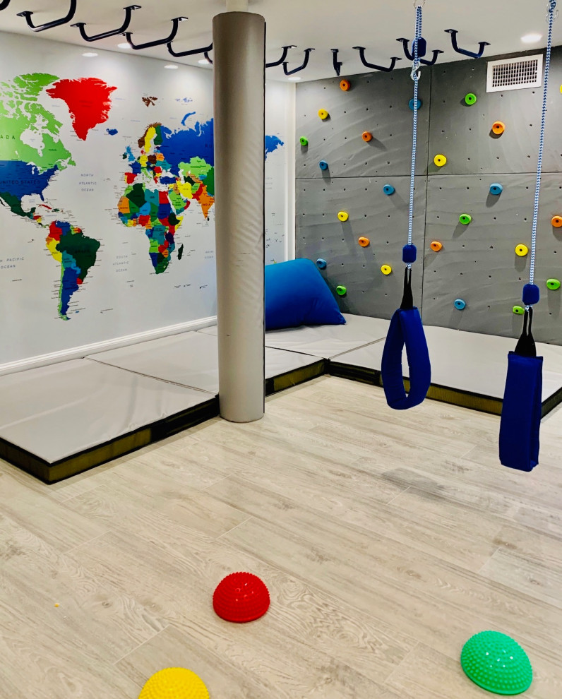 Sensorylicious! - Playroom - mid-sized traditional gender-neutral laminate floor, gray floor, coffered ceiling and wood wall playroom idea in New York with white walls