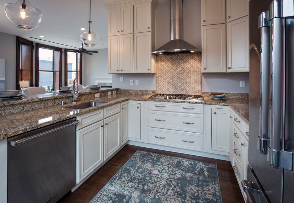 Inspiration for a small transitional u-shaped medium tone wood floor and brown floor open concept kitchen remodel with white cabinets, granite countertops, beige backsplash, stone tile backsplash, stainless steel appliances, no island, an undermount sink and beaded inset cabinets