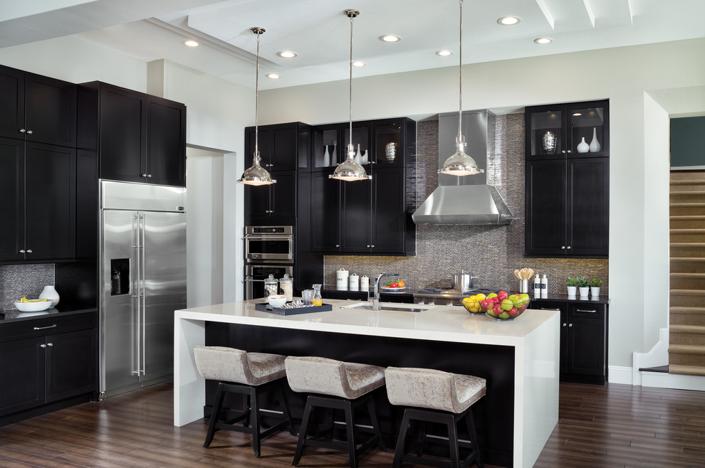 Inspiration for an expansive transitional l-shaped open plan kitchen in Tampa with an undermount sink, recessed-panel cabinets, dark wood cabinets, quartzite benchtops, grey splashback, metal splashback, stainless steel appliances, medium hardwood floors and with island.