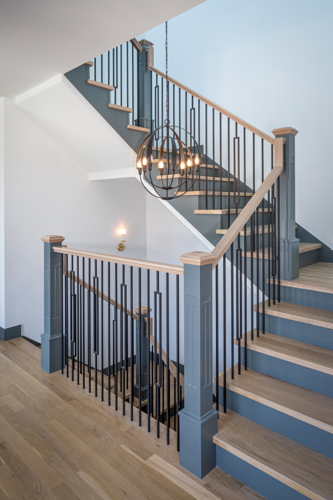 Design ideas for a classic wood u-shaped wood railing staircase in Denver with painted wood risers.