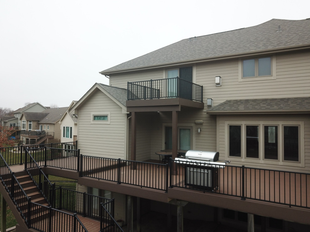 Inspiration for a large backyard second story metal railing deck remodel with no cover