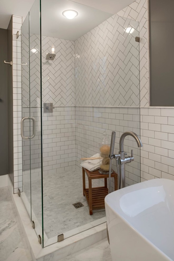Inspiration for a mid-sized transitional master bathroom in Minneapolis with shaker cabinets, white cabinets, a freestanding tub, an open shower, a two-piece toilet, white tile, ceramic tile, grey walls, marble floors, an undermount sink and recycled glass benchtops.