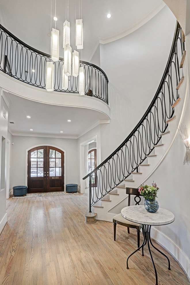 Photo of a large transitional foyer in Houston with grey walls, light hardwood floors, a double front door, a dark wood front door and white floor.