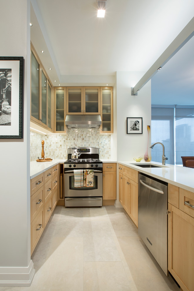 Photo of a large modern u-shaped eat-in kitchen in Toronto with glass-front cabinets and medium wood cabinets.