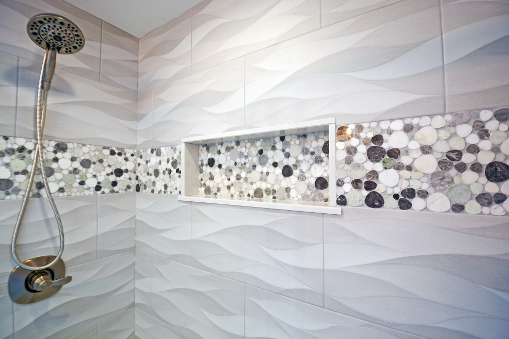Maritim inredning av ett mellanstort vit vitt badrum, med en dusch/badkar-kombination, grå kakel, keramikplattor, blå väggar, klinkergolv i småsten, flerfärgat golv och dusch med skjutdörr