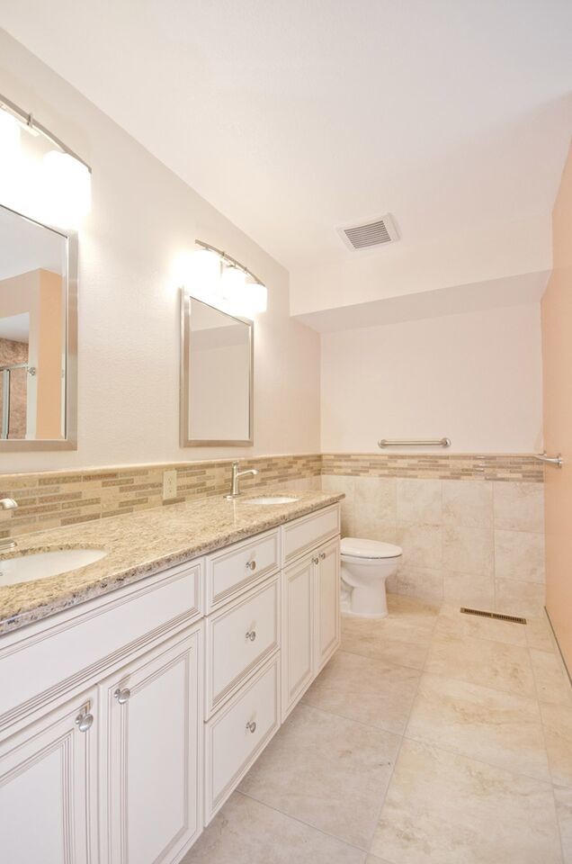 Traditional master bathroom in Other with beaded inset cabinets, white cabinets, an alcove shower, a two-piece toilet, beige tile, multi-coloured tile, matchstick tile, white walls, linoleum floors, an undermount sink and granite benchtops.