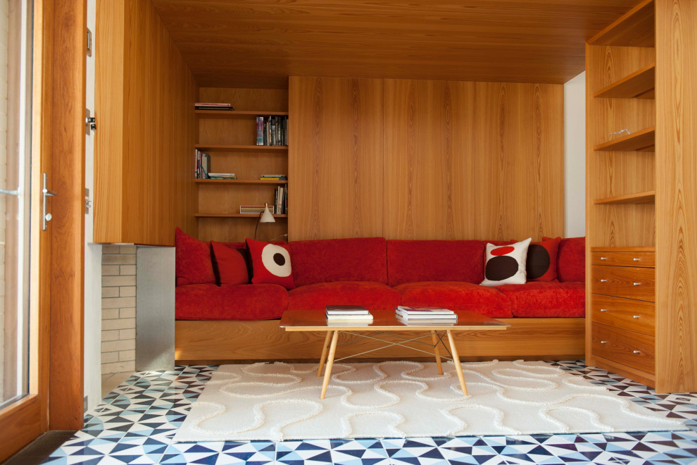 Midcentury family room in New York with brown walls and multi-coloured floor.
